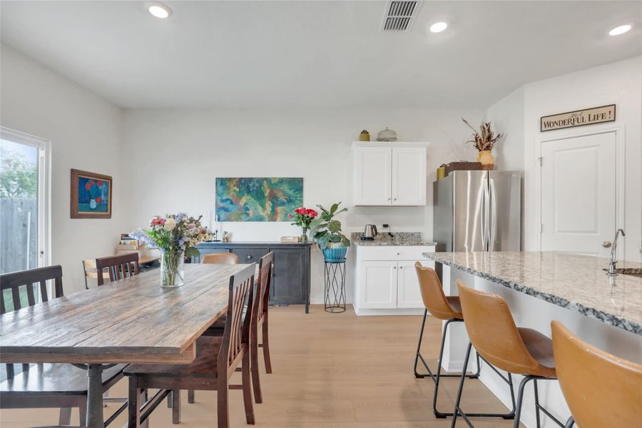 Dining space with recessed lighting and light wood-style floors