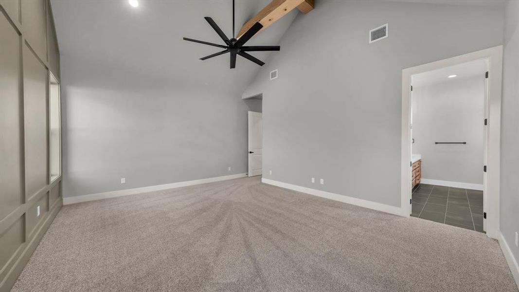 Spacious room with vaulted ceilings and exposed wood beam Spacious room with vaulted ceilings and exposed wood beam