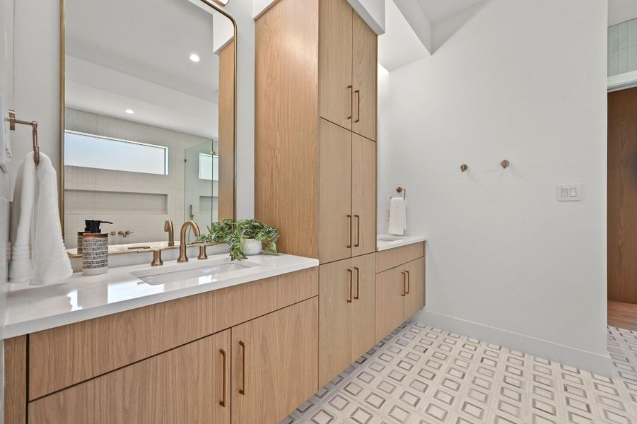 Bathroom featuring two vanities, recessed lighting, and a shower
