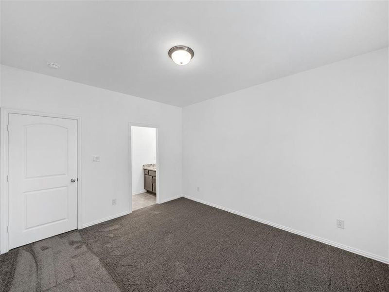 Spare room featuring dark carpet