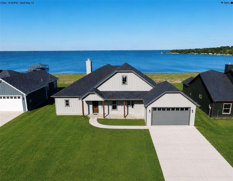 Contemporary exterior featuring light grey siding, a dark asphalt shingle roof, and a prominent chimney Contemporary exterior featuring light grey siding, a dark asphalt shingle roof, and a prominent chimney