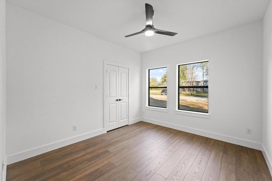 Unfurnished room featuring hardwood / wood-style floors and ceiling fan