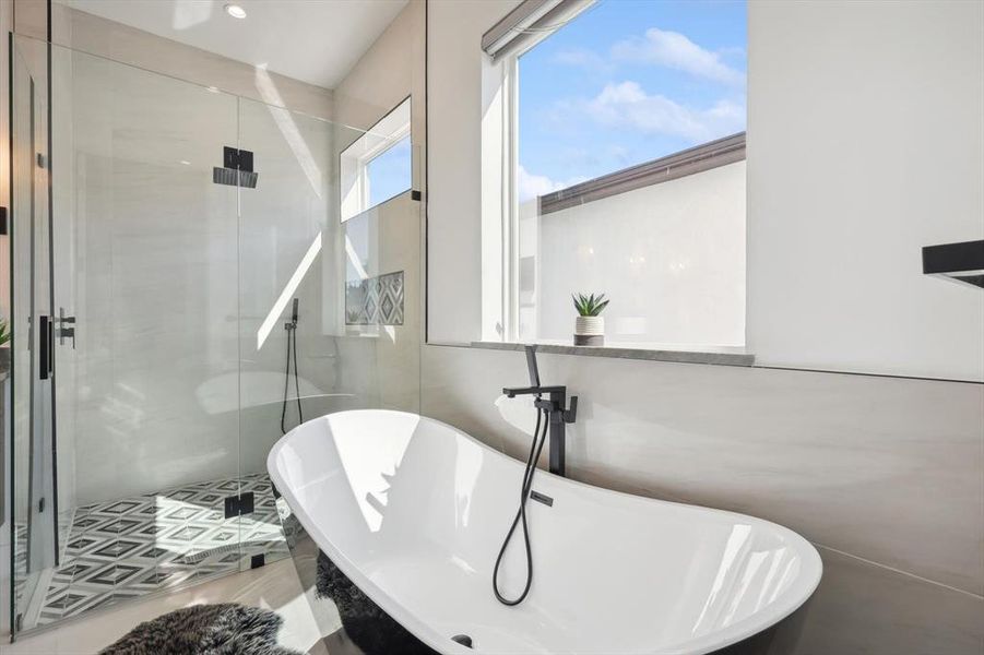 Bathroom featuring tile patterned flooring and plus walk in shower