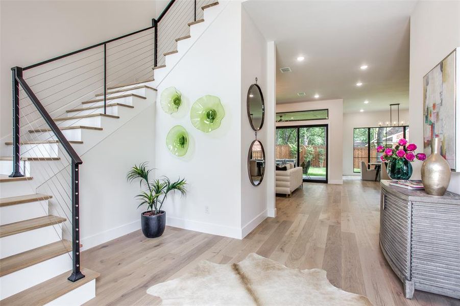 Foyer featuring light hardwood / wood-style flooring and a chandelier