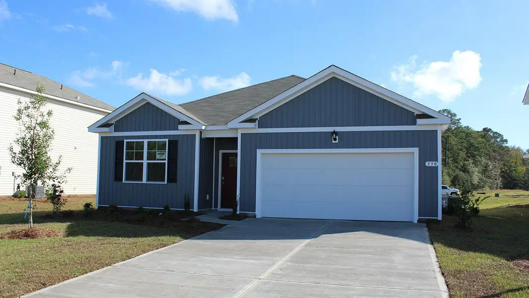 Front exterior of a new home in Auberon Woods, Conway, SC, highlighting curb appeal (Image 2).