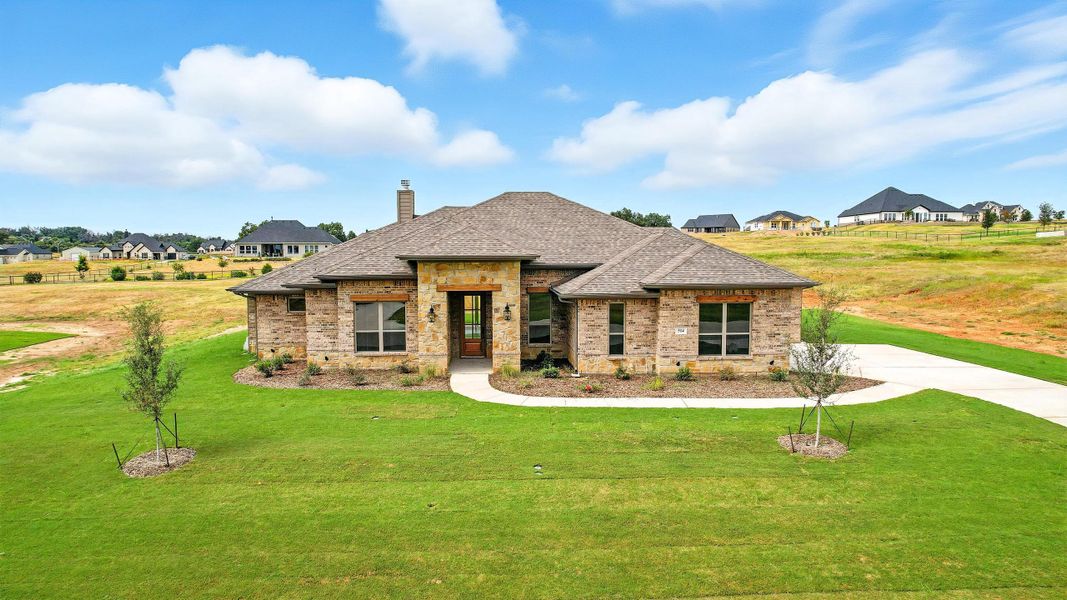 Front exterior of a new home in Rocky Top Ranch, Reno, TX, highlighting curb appeal (Image 1). Front exterior of a new home in Rocky Top Ranch, Reno, TX, highlighting curb appeal (Image 1).