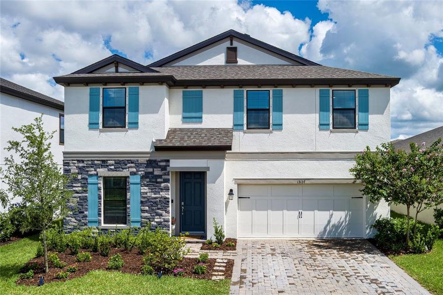 Front exterior of a new home in Crosswind Point, Parrish, FL, highlighting curb appeal (Image 23).