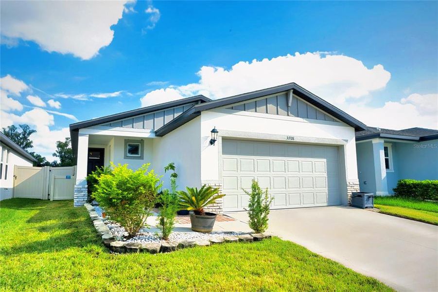 Front exterior of a new home in Park East, Plant City, FL, highlighting curb appeal (Image 20). Front exterior of a new home in Park East, Plant City, FL, highlighting curb appeal (Image 20).