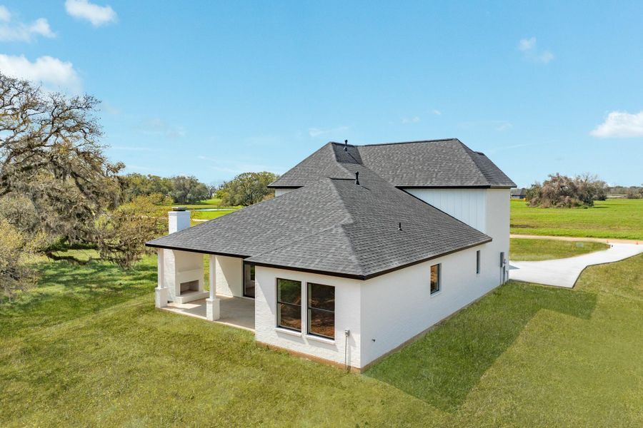 The back setting of this home offers a covered patio with an out door fireplace perfect for relaxing and enjoying the peace and tranquillity this property offers. Sliding back doors that allow the indoor living room and out door patio to become an indoor/outdoor living expierence.