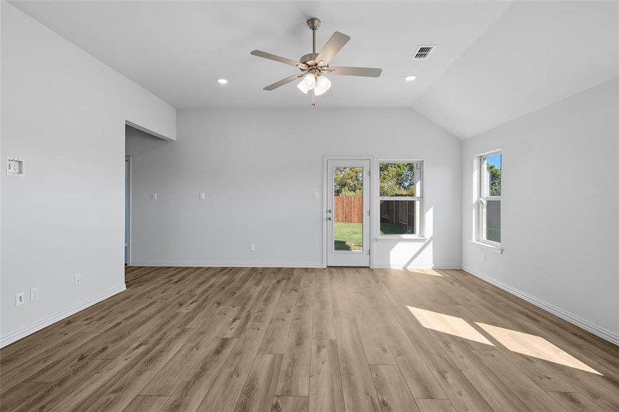 Unfurnished room with light wood-style floors, recessed lighting, a ceiling fan, and vaulted ceiling Unfurnished room with light wood-style floors, recessed lighting, a ceiling fan, and vaulted ceiling