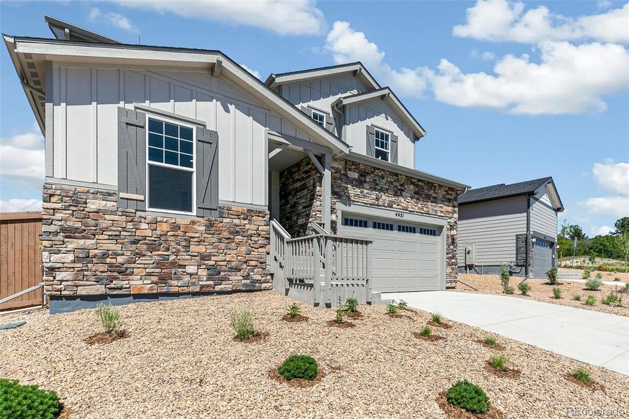 Front exterior of a new home in Terrain Oak Valley, Castle Rock, CO, highlighting curb appeal (Image 22).