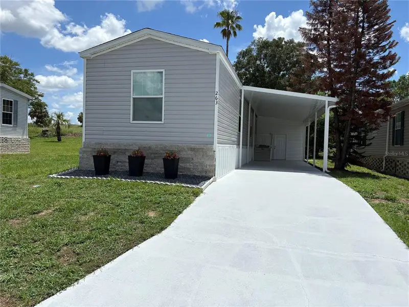 Front exterior of a new home in , Lake Wales, FL, highlighting curb appeal (Image 1). Front exterior of a new home in , Lake Wales, FL, highlighting curb appeal (Image 1).
