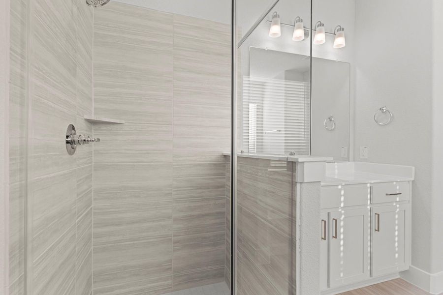 A closer view of the beautifully tiled walk-in shower highlights its clean, modern design and relaxing atmosphere. Sleek fixtures and neutral tile tones add a touch of sophistication to this luxurious primary bath. A closer view of the beautifully tiled walk-in shower highlights its clean, modern design and relaxing atmosphere. Sleek fixtures and neutral tile tones add a touch of sophistication to this luxurious primary bath.