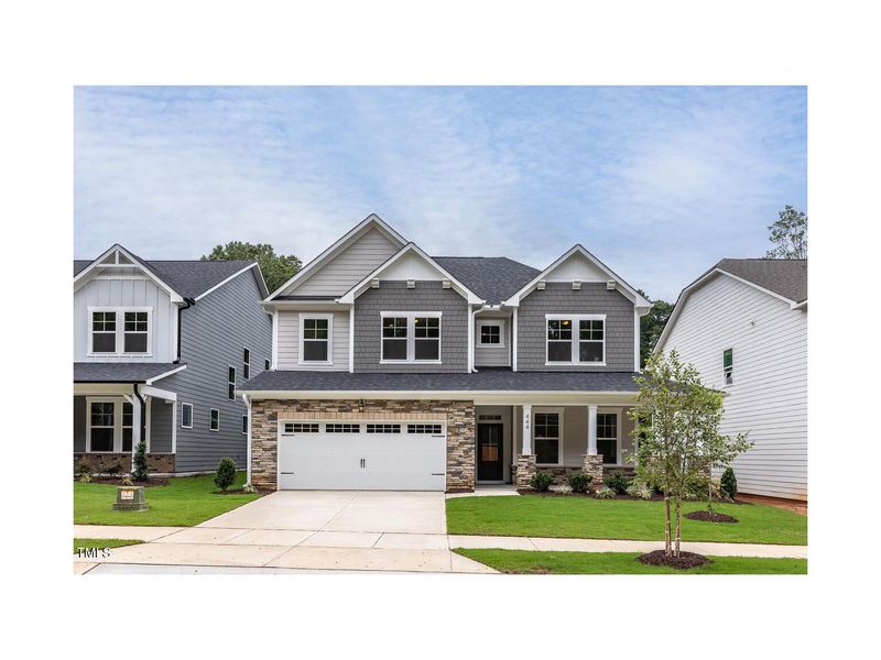 Front exterior of a new home in Sage on North Main, Wake Forest, NC, highlighting curb appeal (Image 1). Front exterior of a new home in Sage on North Main, Wake Forest, NC, highlighting curb appeal (Image 1).