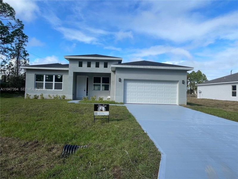 Front exterior of a new home in , Palm Bay, FL, highlighting curb appeal (Image 9).