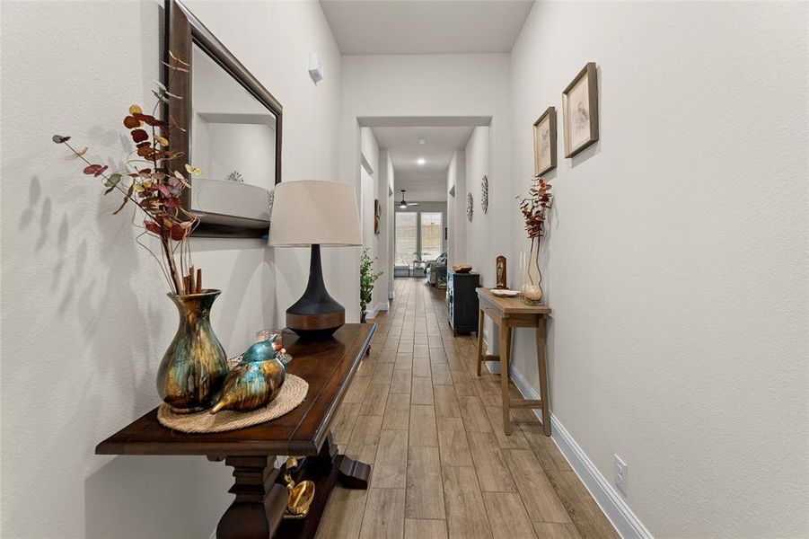 Hall with light wood-type flooring and baseboards Hall with light wood-type flooring and baseboards