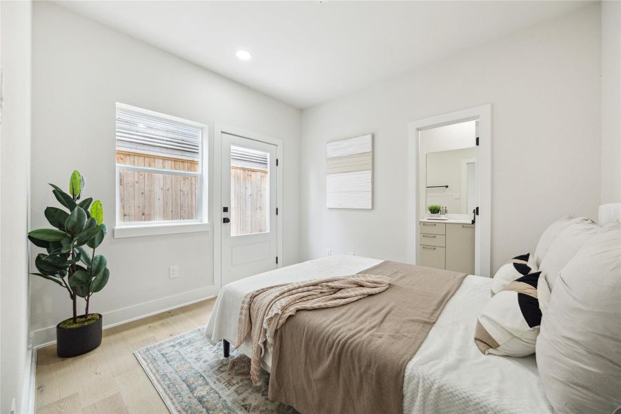 Cozy first-floor bedroom with ample natural light, private patio access, and en-suite convenience.