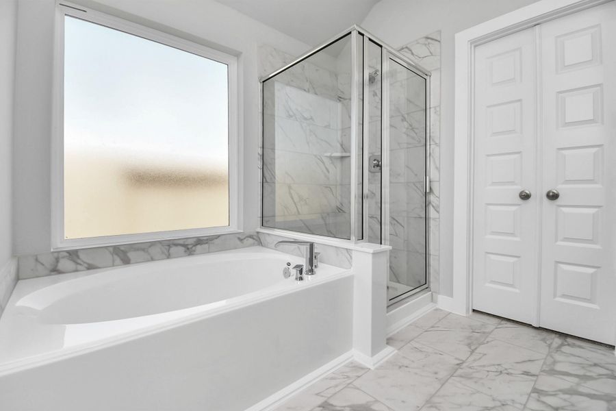 The primary en-suite has a soaking tub to give you that spa experience. The large privacy window allow lots of nature light in the space. Sample photo of completed home with similar floor plan. As-built interior colors and selections may vary. The primary en-suite has a soaking tub to give you that spa experience. The large privacy window allow lots of nature light in the space. Sample photo of completed home with similar floor plan. As-built interior colors and selections may vary.