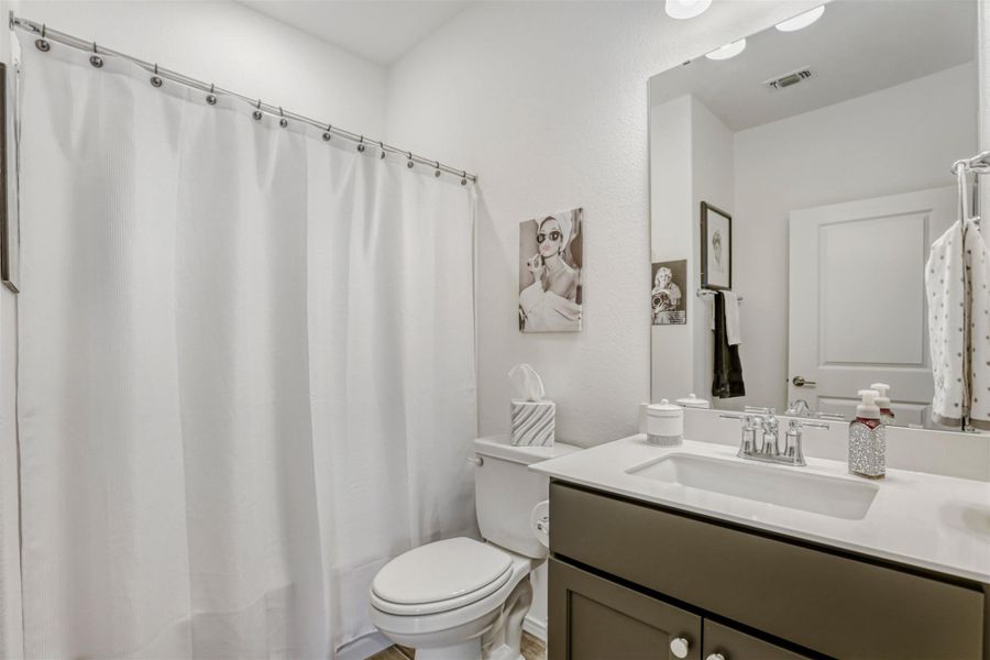 Bathroom with vanity and a shower