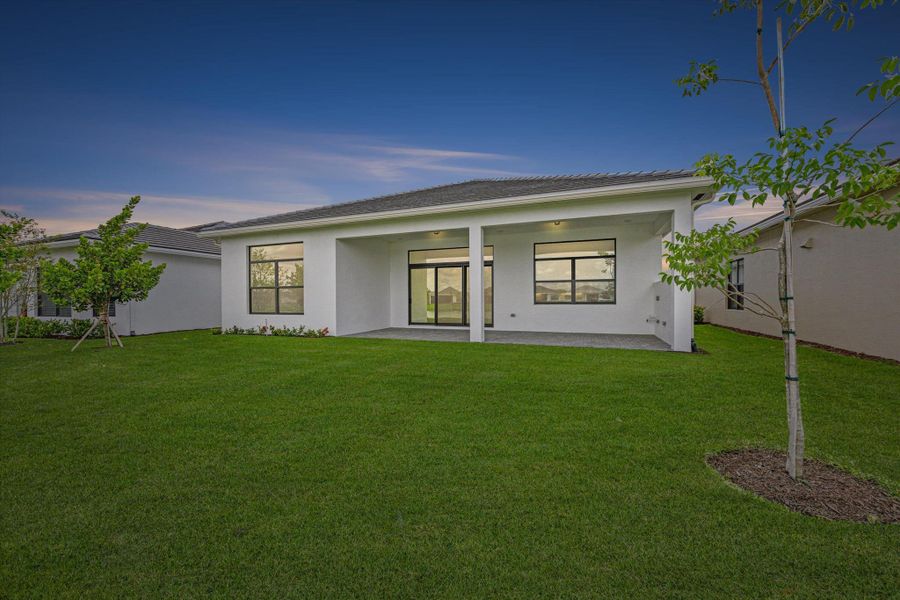 Front exterior of a new home in Cresswind Palm Beach at Westlake, Westlake, FL, highlighting curb appeal (Image 26). Front exterior of a new home in Cresswind Palm Beach at Westlake, Westlake, FL, highlighting curb appeal (Image 26).