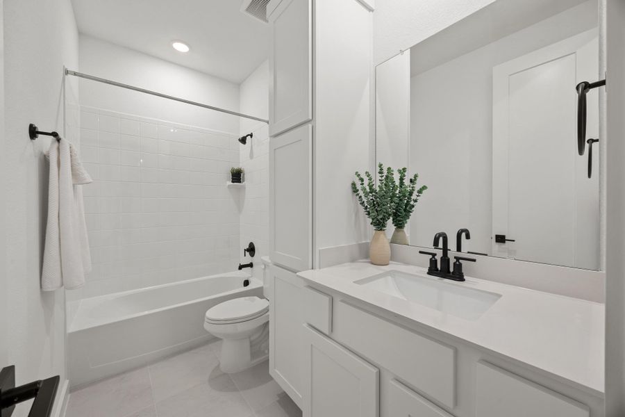 Bathroom with vanity, shower / bath combination, light tile patterned flooring, and recessed lighting