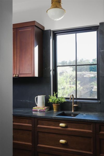 Smart storage for everyday life. In addition to the butler's pantry, the kitchen includes an expansive walk-in closet and pantry area, providing ample room for bulk storage and keeping the main surfaces pristine and organized.