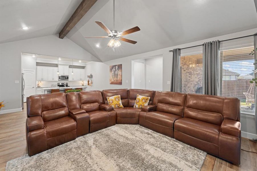Living room featuring light wood-style floors, a ceiling fan, and recessed lighting
