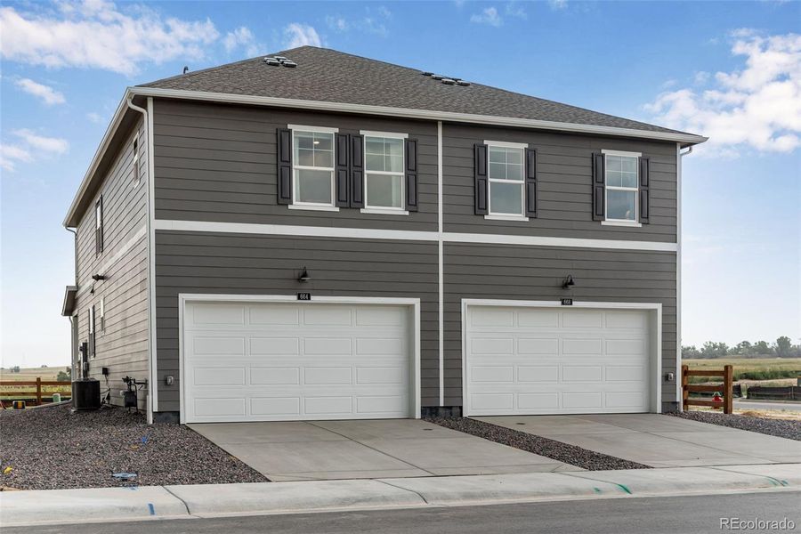 Front exterior of a new home in Vista Meadows, Fort Lupton, CO, highlighting curb appeal (Image 19).