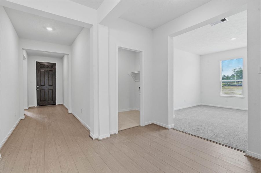 Across the home from the secondary bedrooms and bathroom is a hallway that leads to the Den and laundry room. Across the home from the secondary bedrooms and bathroom is a hallway that leads to the Den and laundry room.