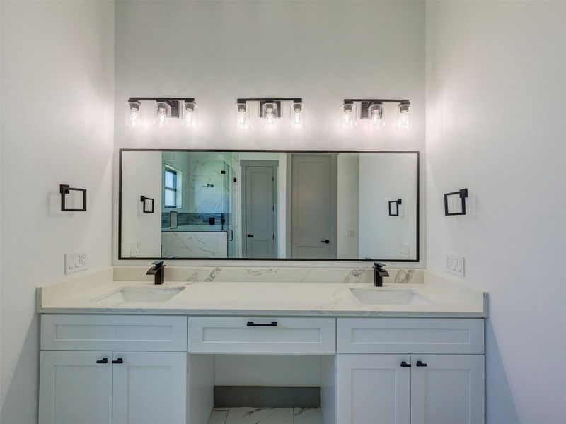 Clean lines and a double vanity define this modern, elegant bathroom space.