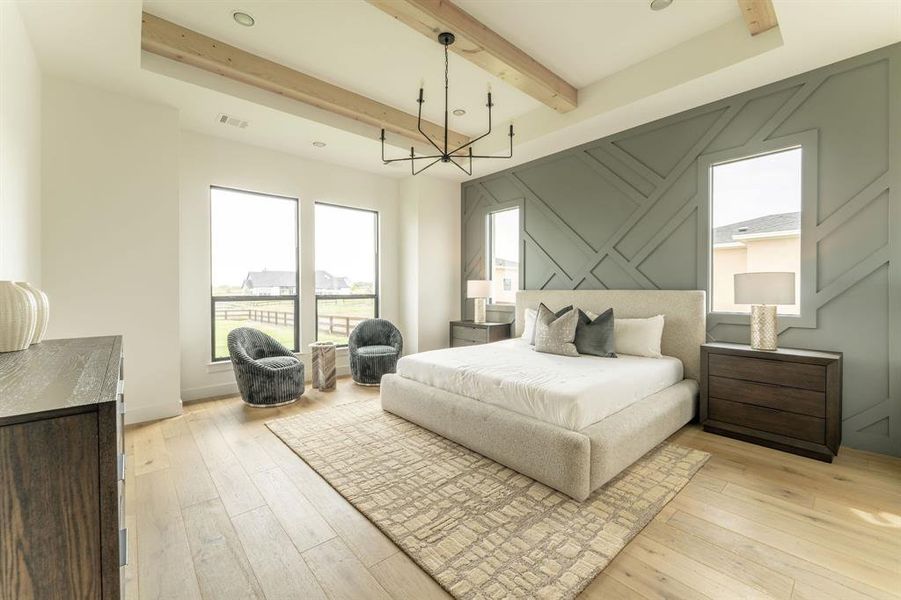 Bedroom with a chandelier, light wood-style floors, and beamed ceiling Bedroom with a chandelier, light wood-style floors, and beamed ceiling