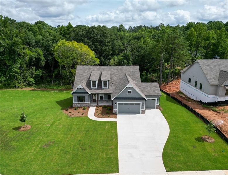 Front exterior of a new home in Riverwalk, Monroe, GA, highlighting curb appeal (Image 26). Front exterior of a new home in Riverwalk, Monroe, GA, highlighting curb appeal (Image 26).