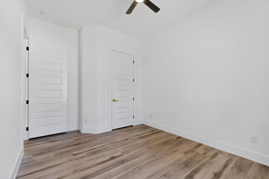 Natural wood flooring complements this generously sized room, ready for your personalized touch.