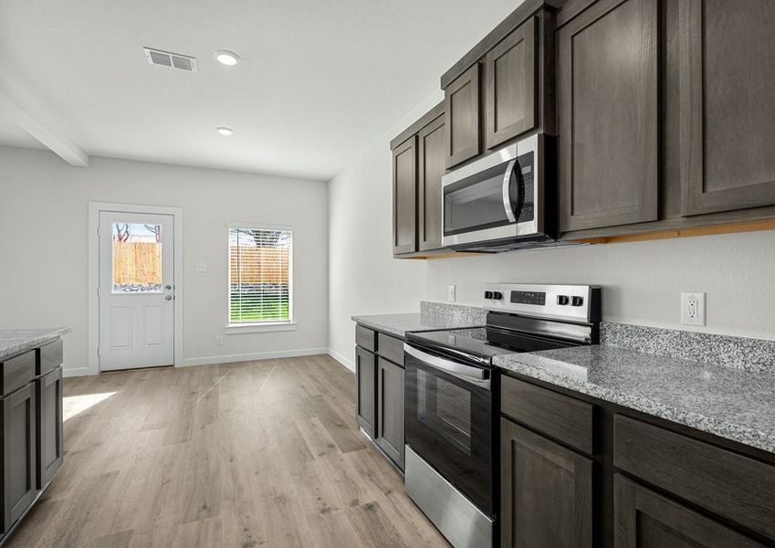 The kitchen has sprawling granite countertops.