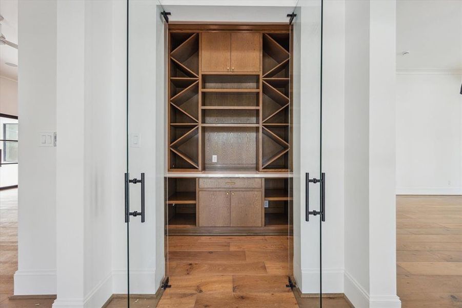 This sophisticated wine room, with a glass door entry, offers storage for over 200 bottles, perfect for any wine connoisseur. Conveniently located near the dining room and kitchen, it ensures easy access to your favorite vintages for any occasion.