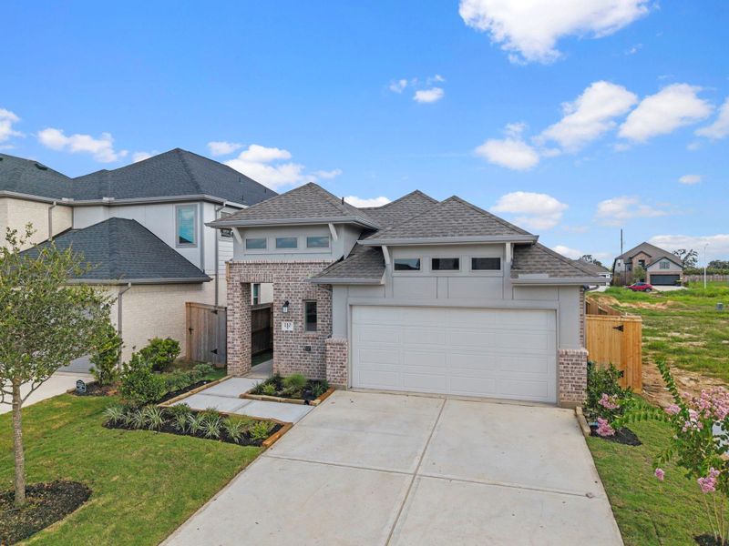 Front exterior of a new home in Candela, Richmond, TX, highlighting curb appeal (Image 22). Front exterior of a new home in Candela, Richmond, TX, highlighting curb appeal (Image 22).