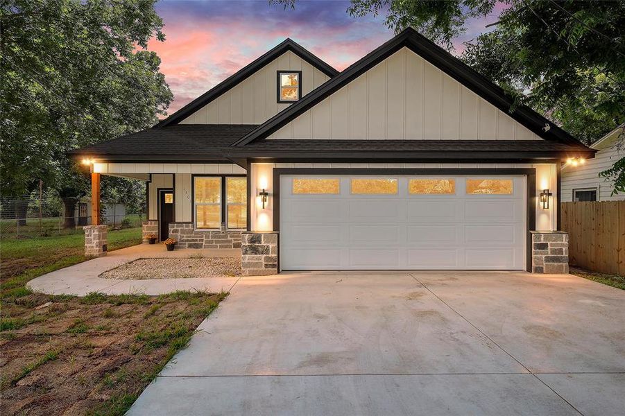 Contemporary home exterior featuring board and batten siding and stone accents Contemporary home exterior featuring board and batten siding and stone accents