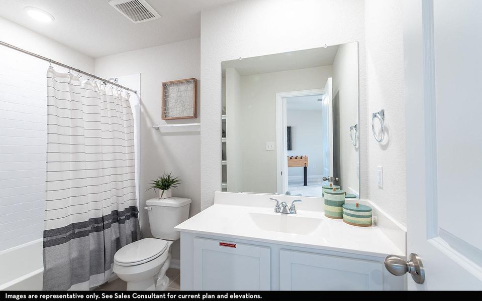 Bathroom featuring vanity and shower / bath combo with shower curtain