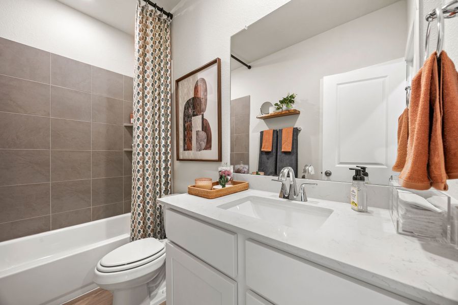 A bathroom with a tub sink and toilet. A bathroom with a tub sink and toilet.