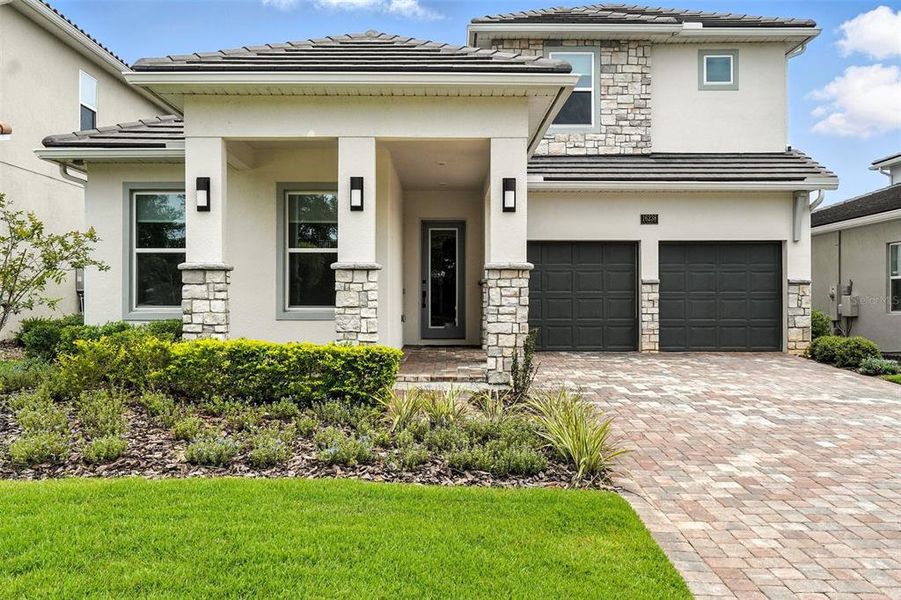 Front exterior of a new home in Bella Collina, Montverde, FL, highlighting curb appeal (Image 1).