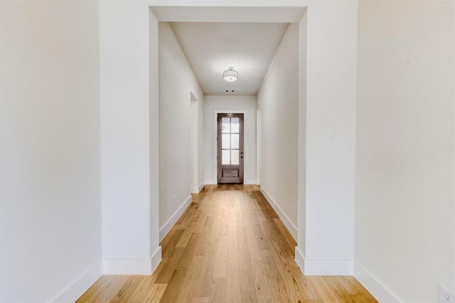 Entryway with wood finished floors and baseboards