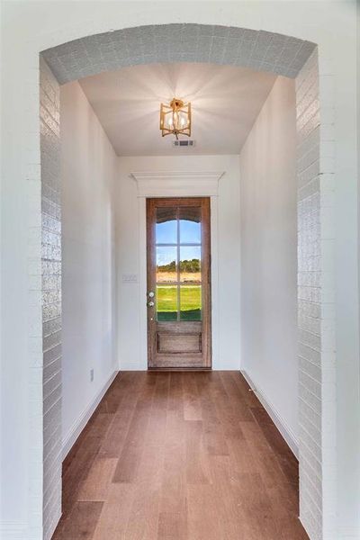 Entryway featuring wood finished floors and baseboards Entryway featuring wood finished floors and baseboards