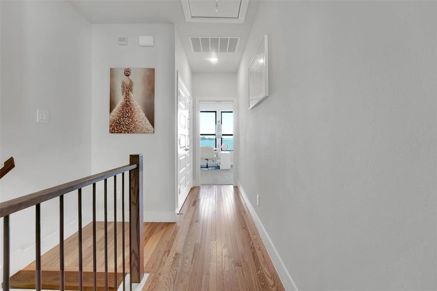 Hall with light hardwood / wood-style flooring