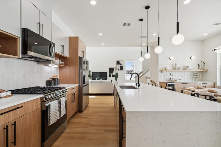 With uninterrupted sightlines from the island to the living room, this layout is designed for seamless hosting and everyday ease.