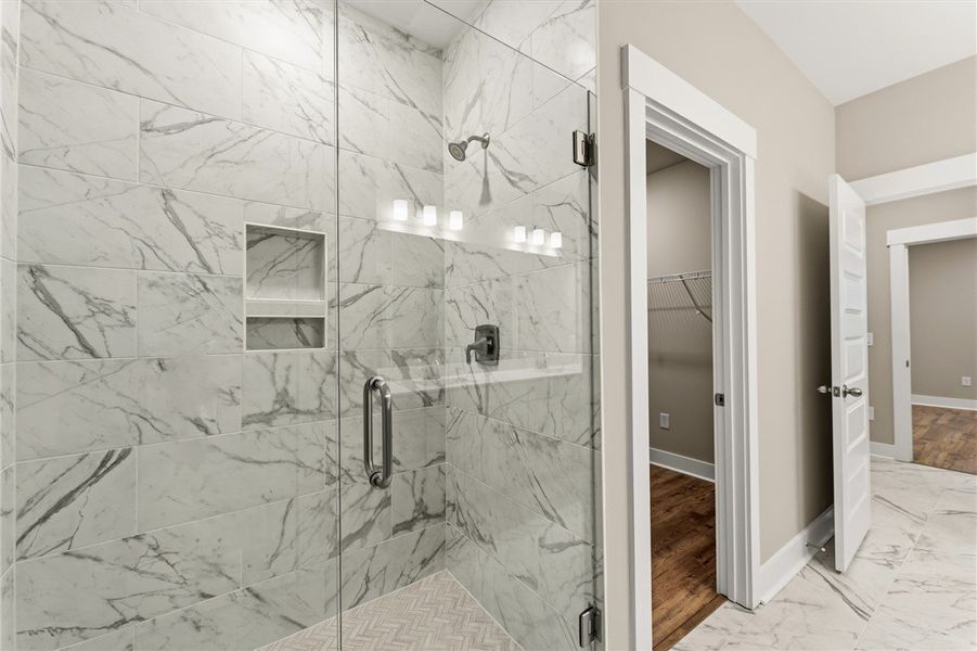 A spacious bathroom showcases a walk-in shower wit