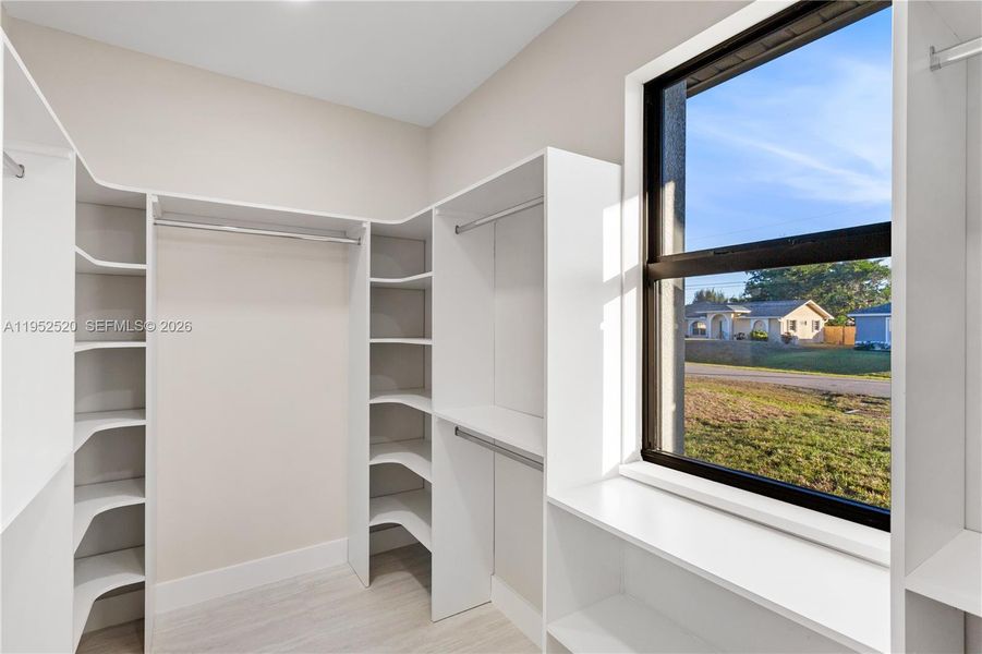 Primary Suite Closet: WALK-IN CLOSET w/ BUILT-IN SHELVING & HANGING RACKS