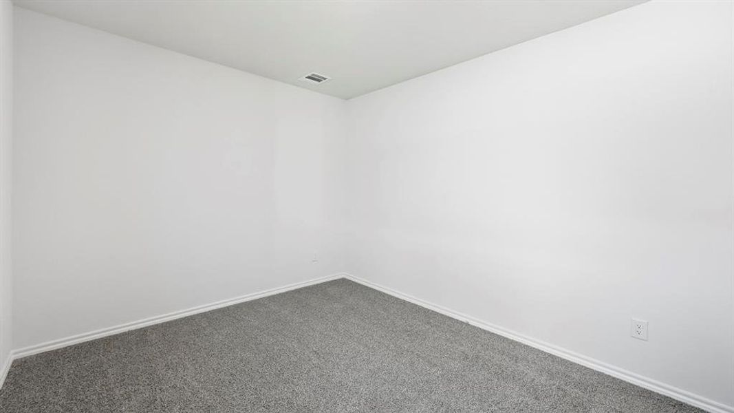Spare room featuring carpet floors and baseboards Spare room featuring carpet floors and baseboards