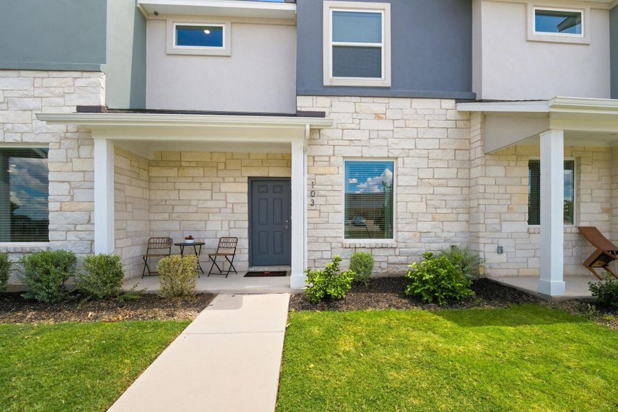 Clean lines and modern stonework define the exterior of this inviting townhouse entrance.