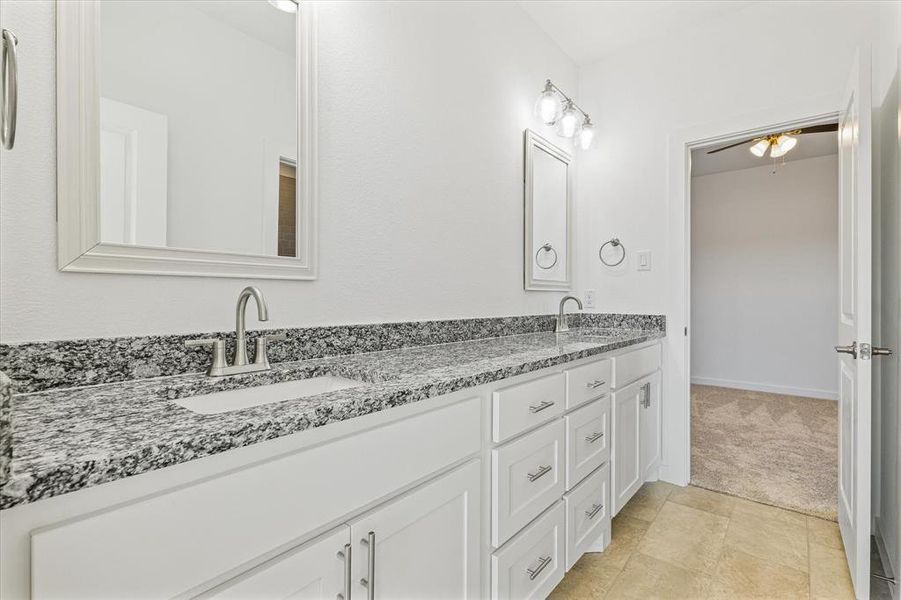 Bathroom featuring tile patterned flooring, vanity, and ceiling fan Bathroom featuring tile patterned flooring, vanity, and ceiling fan
