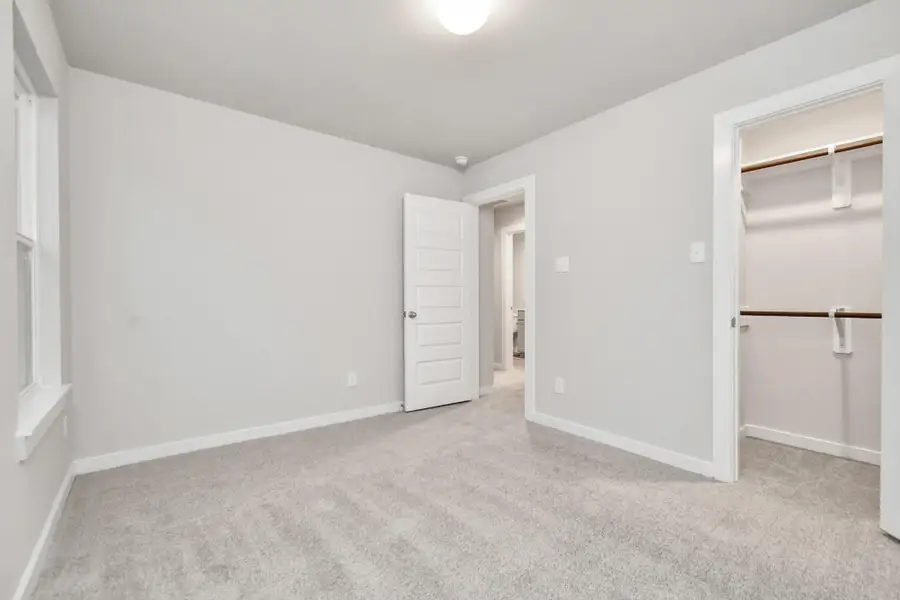 Generously sized secondary bedrooms featuring spacious closets, soft and inviting carpeting underfoot, large windows allowing plenty of natural light, and the added touch of privacy blinds for your personal retreat. Sample photo of completed home with similar floor plan. As-built interior colors and selections may vary. Generously sized secondary bedrooms featuring spacious closets, soft and inviting carpeting underfoot, large windows allowing plenty of natural light, and the added touch of privacy blinds for your personal retreat. Sample photo of completed home with similar floor plan. As-built interior colors and selections may vary.